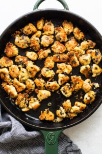 Chicken nuggets in a skillet with a towel.