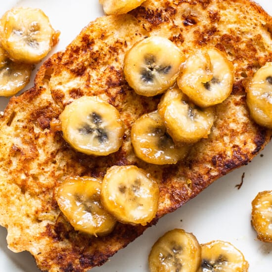 French toast with banana slices on a plate.