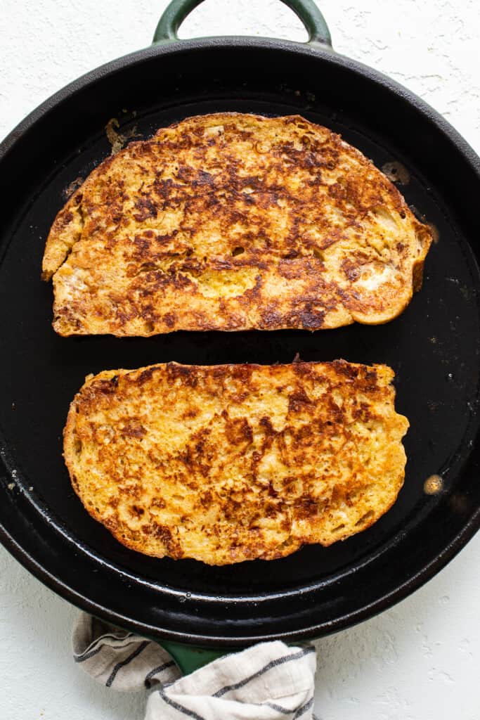 Two slices of french toast in a skillet.