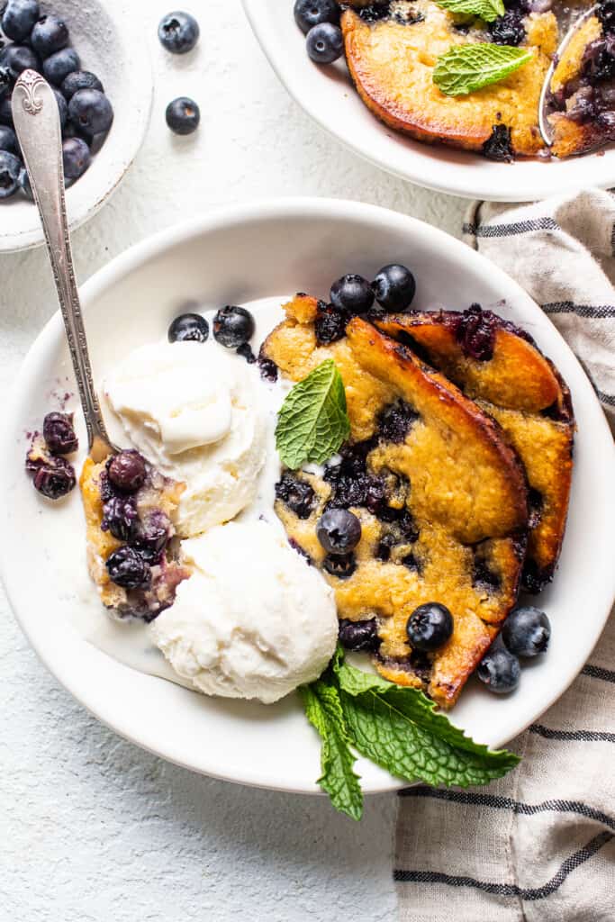 blueberry cobbler with ice cream in bowl.