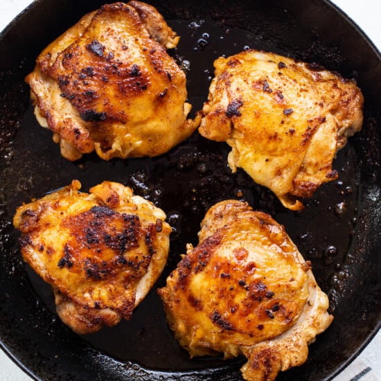 Grilled chicken breasts in a skillet.