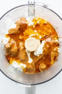 A food processor filled with peanut butter and whipped cream.