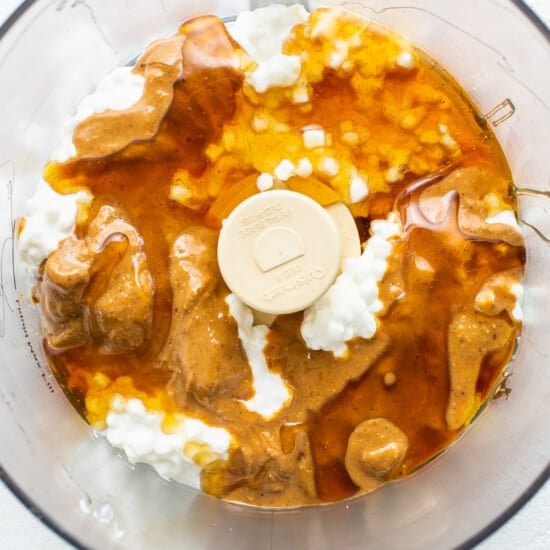 A food processor filled with peanut butter and whipped cream.