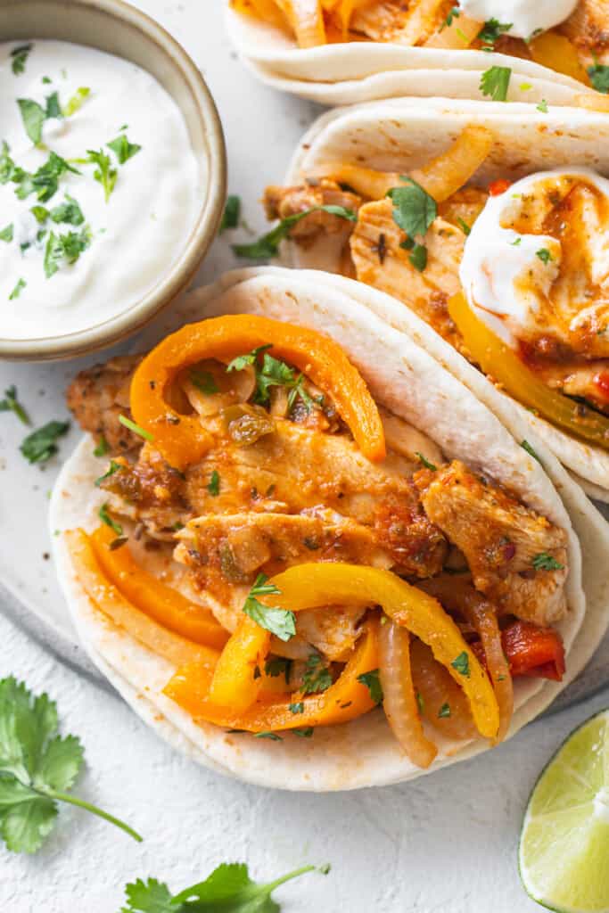 Chicken tacos with peppers and sour cream.
