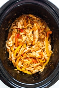 Chicken and peppers in a slow cooker.