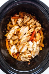 Chicken and peppers in a slow cooker.