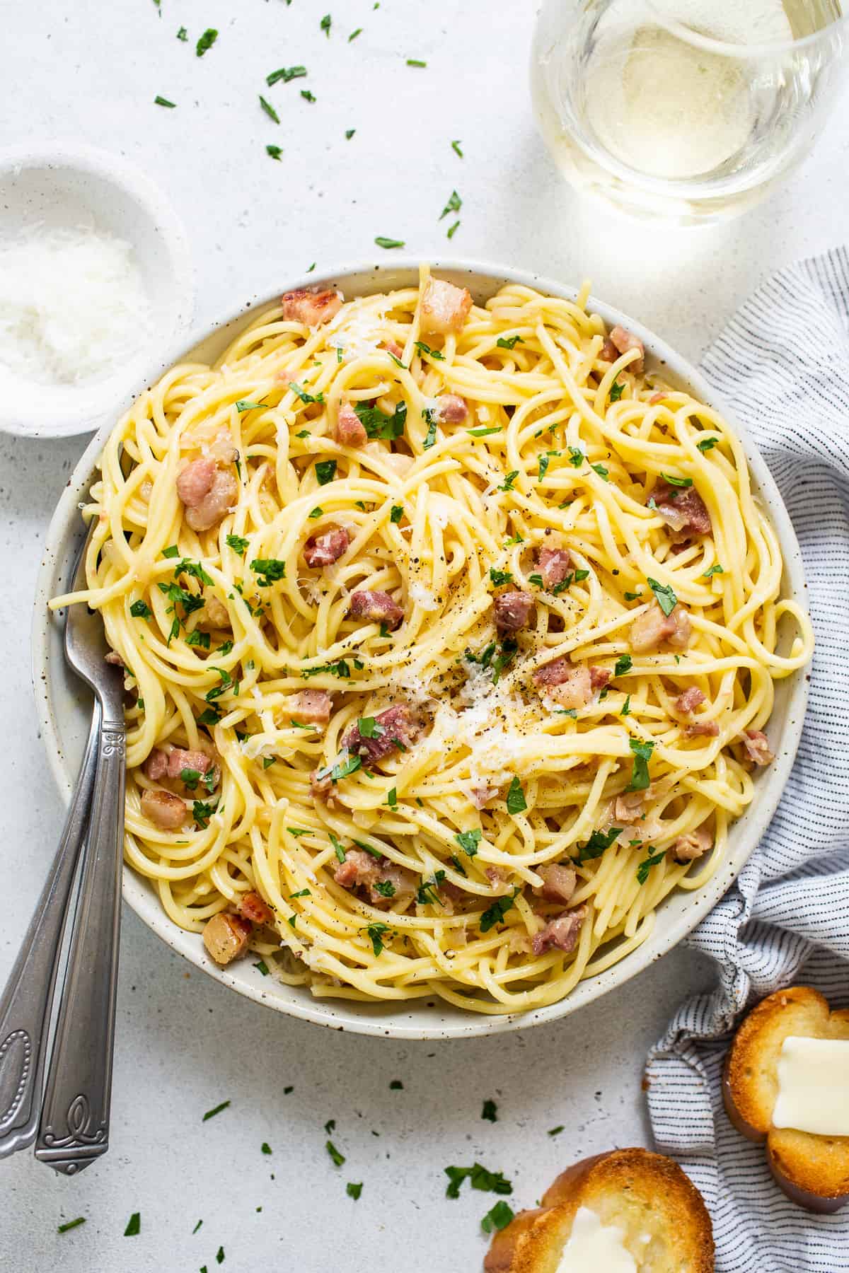 A bowl of spaghetti with bacon and parmesan.