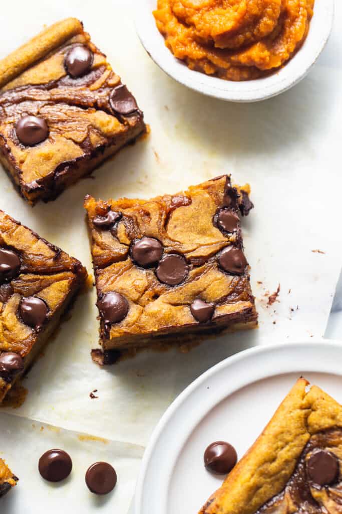 Chocolate chip cookie bars on a white plate.