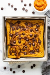 Pumpkin bread in a baking pan with chocolate chips.