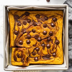 Pumpkin bread in a baking pan with chocolate chips.