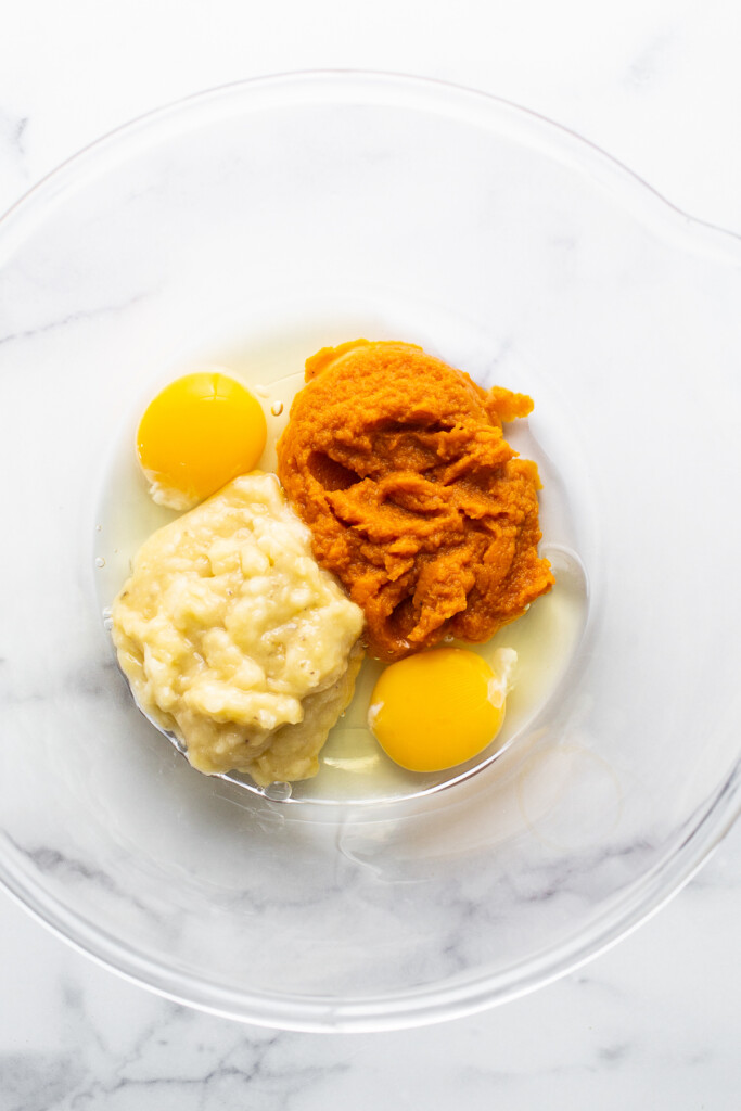 Two eggs and mashed sweet ،ato in a bowl.