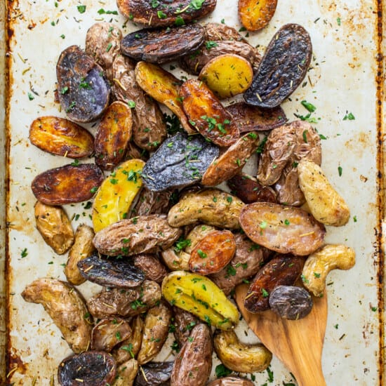 roasted potatoes with herbs on top.