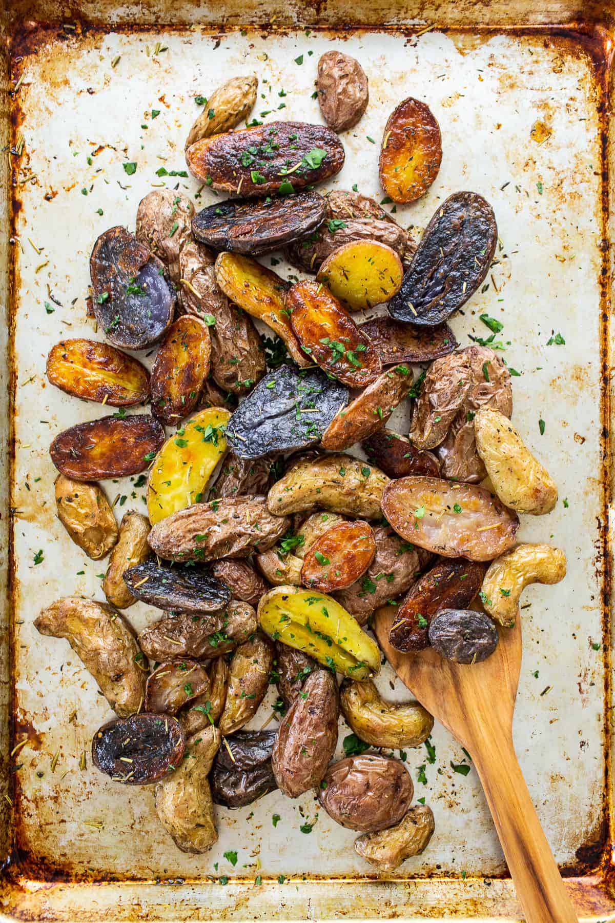 roasted potatoes with herbs on top.