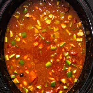 A crock pot full of soup and vegetables.