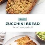 zucchini bread on a plate with butter on top.