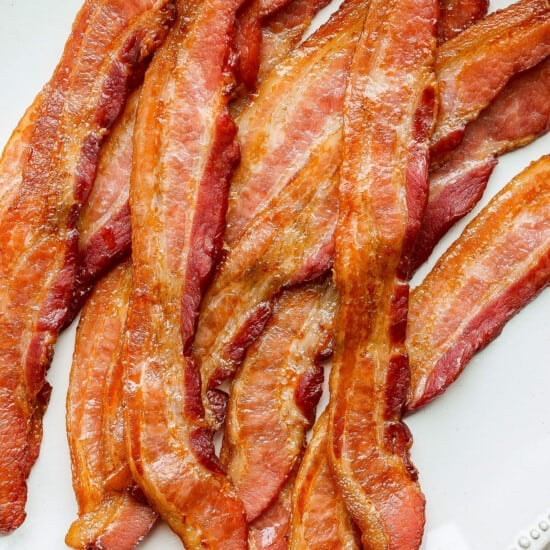 a plate of bacon on a white plate.