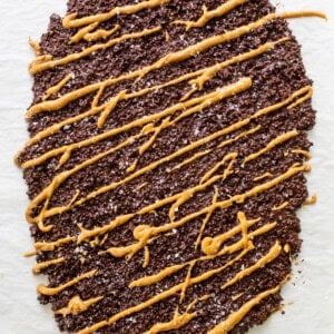 a piece of chocolate cake with caramel drizzle on top.