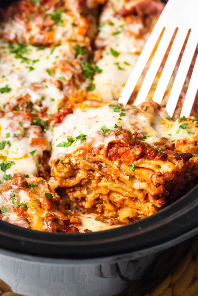 a close up of a fork in a casserole dish.