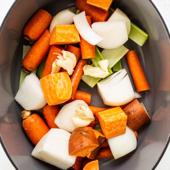 a pan filled with carrots, onions and celery.