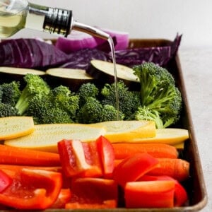 a tray filled with vegetables and a bottle of wine.