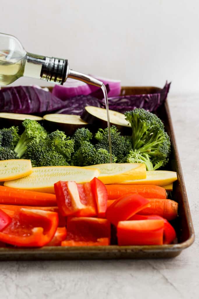 a tray filled with vegetables and a bottle of wine.