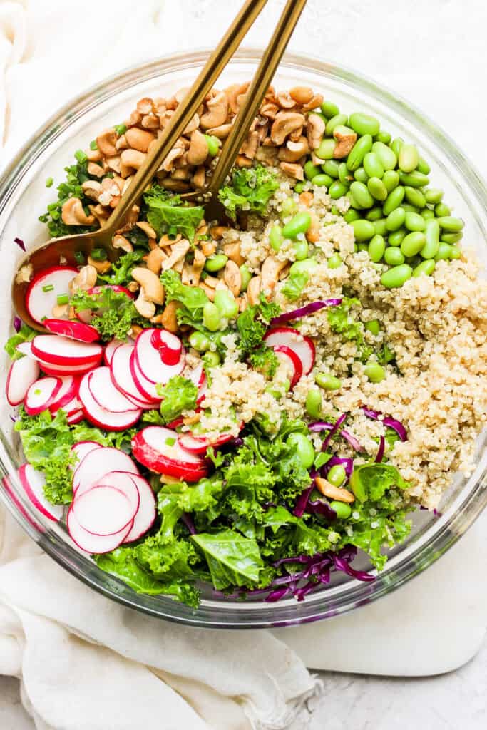 a bowl of quinoa salad with radishes and cashews.