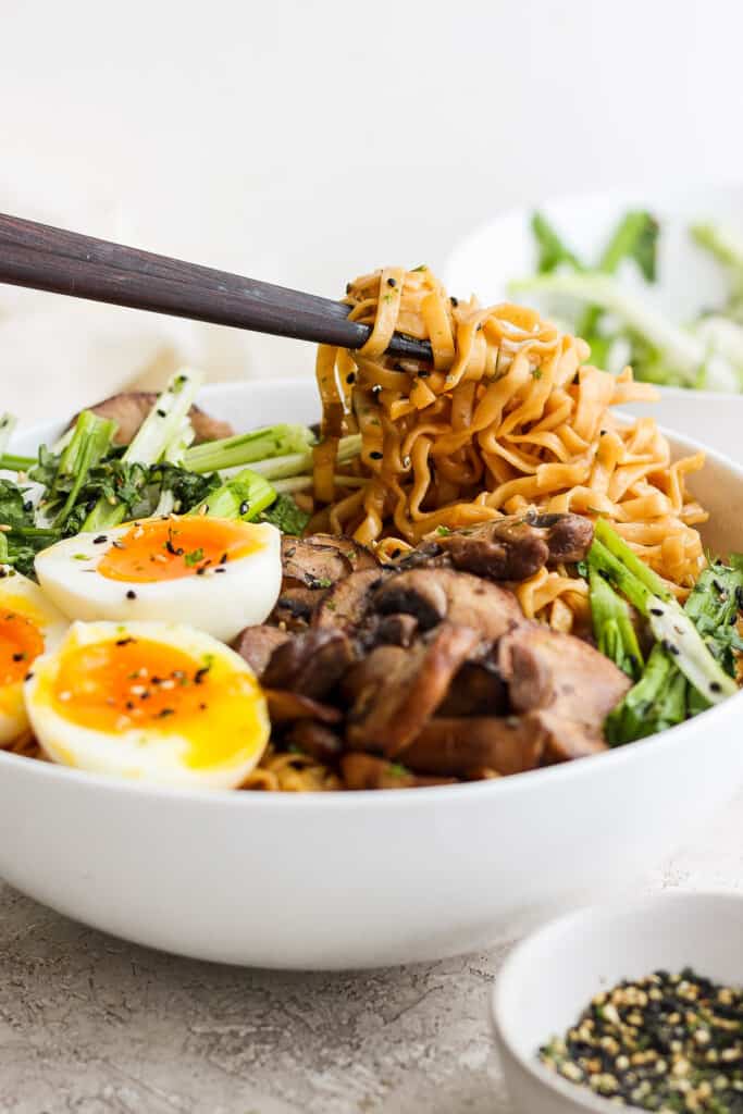 a bowl of asian noodle bowl with an egg and vegetables.