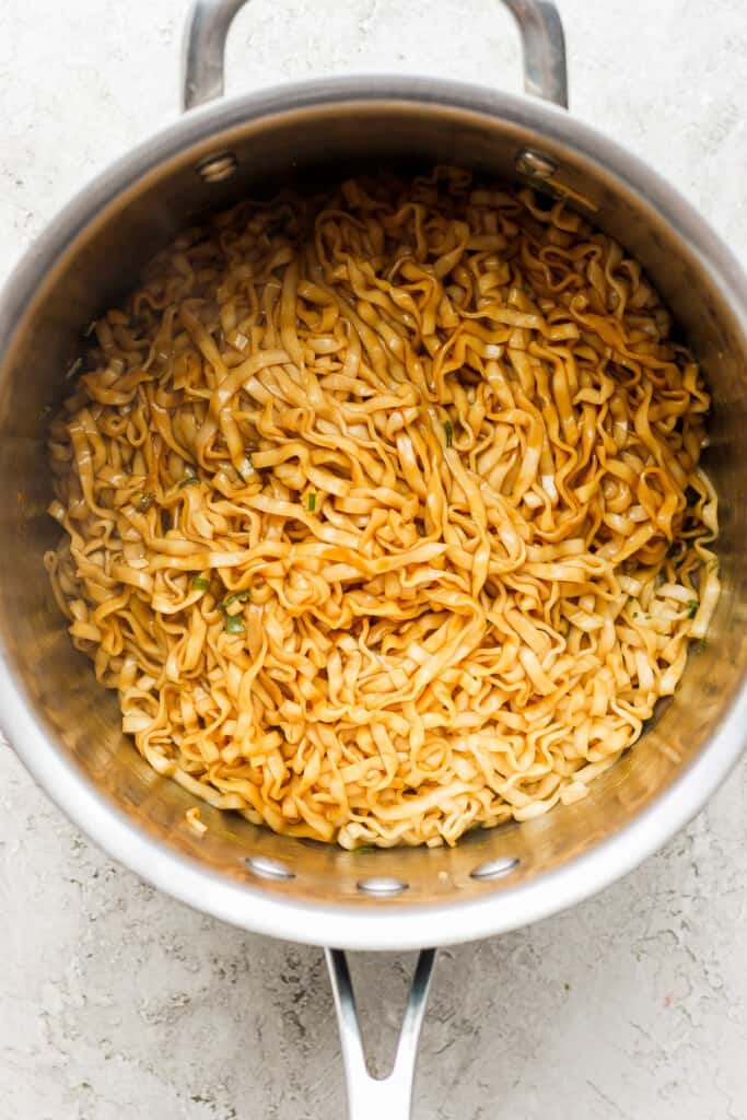 a pan with noodles in it on a white surface.