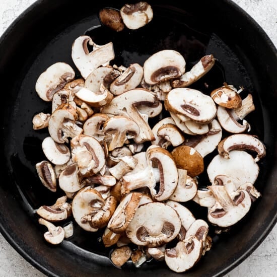 mushrooms in a skillet on a white background.