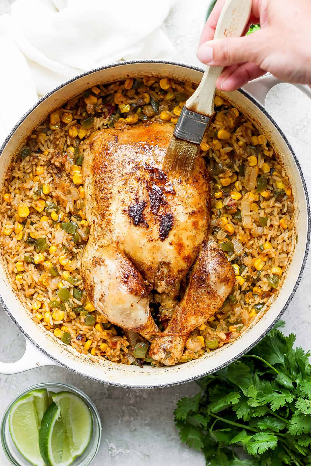 a person is slicing a chicken and rice in a skillet.