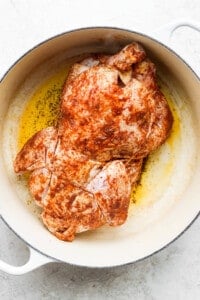 roasted chicken in a skillet on a white background.