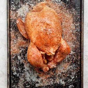 a roasted chicken on a baking sheet.
