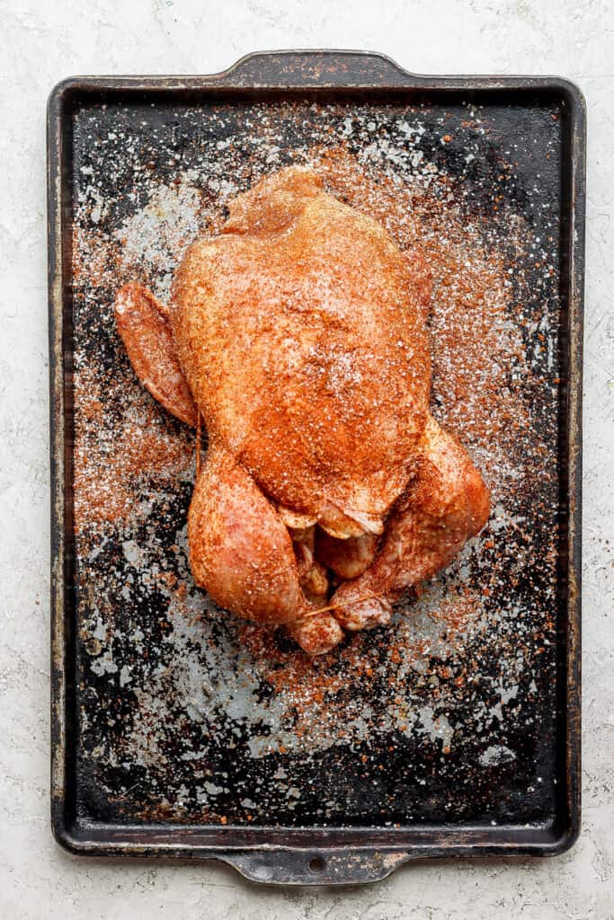 a roasted chicken on a baking sheet.