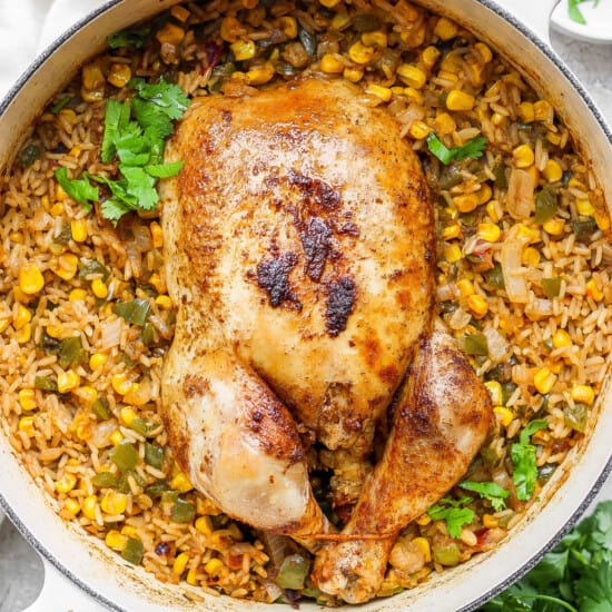 chicken with rice and corn in a skillet.