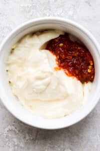 a bowl of whipped cream with a red sauce.