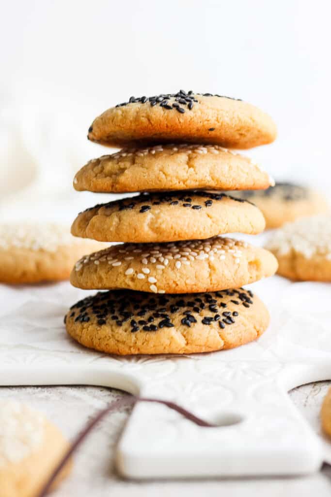 a stack of cookies with sesame seeds on top.