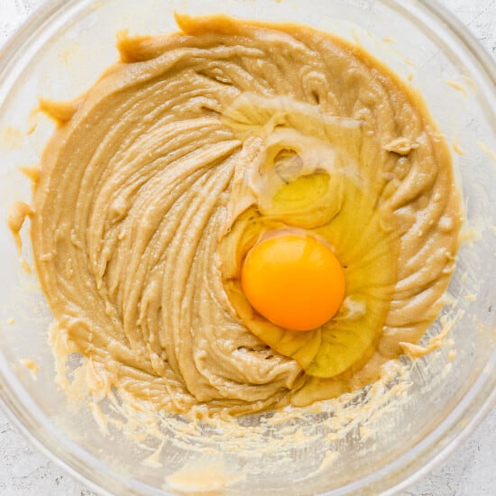 a bowl of peanut butter with an egg in it.