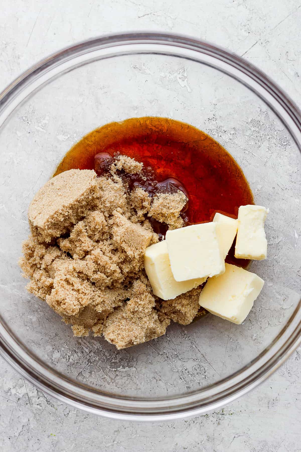 a bowl filled with butter and sugar.