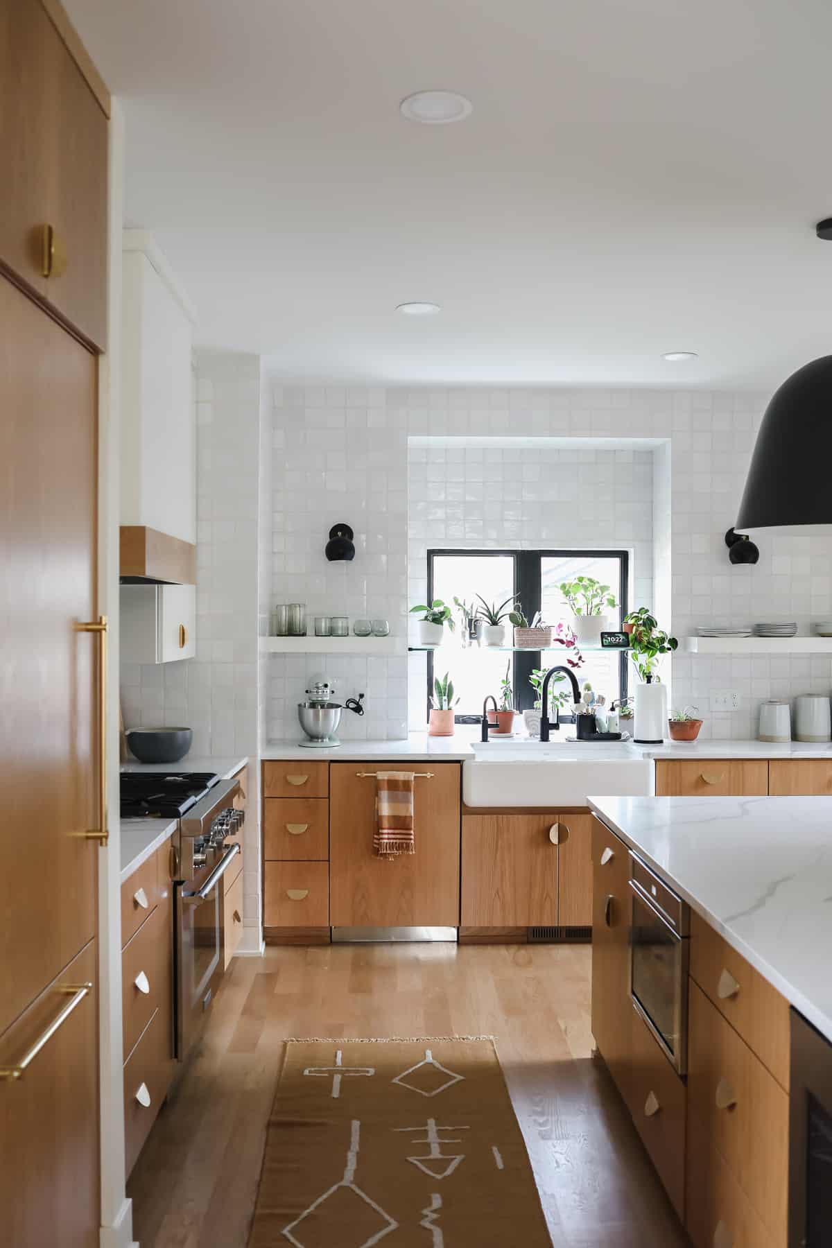 kitchen with white tile and black light fixture.