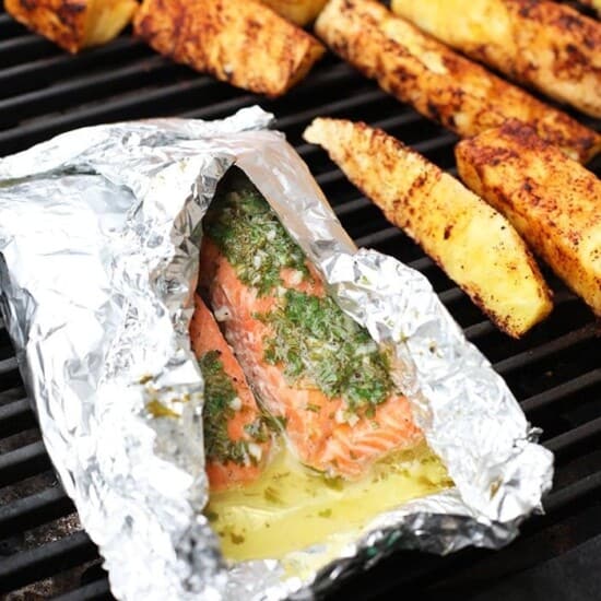 Grilled salmon in foil on a grill.