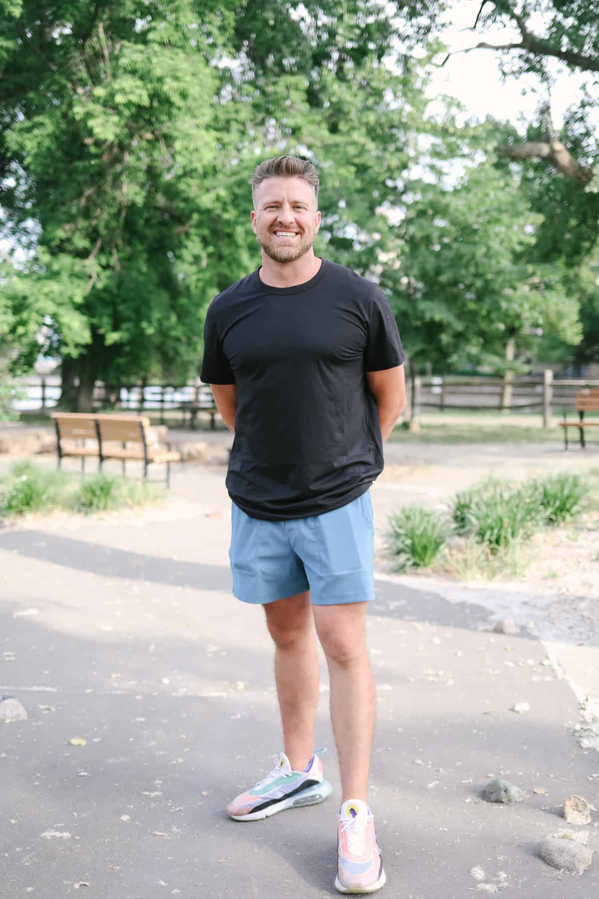 a man standing in the middle of a park.