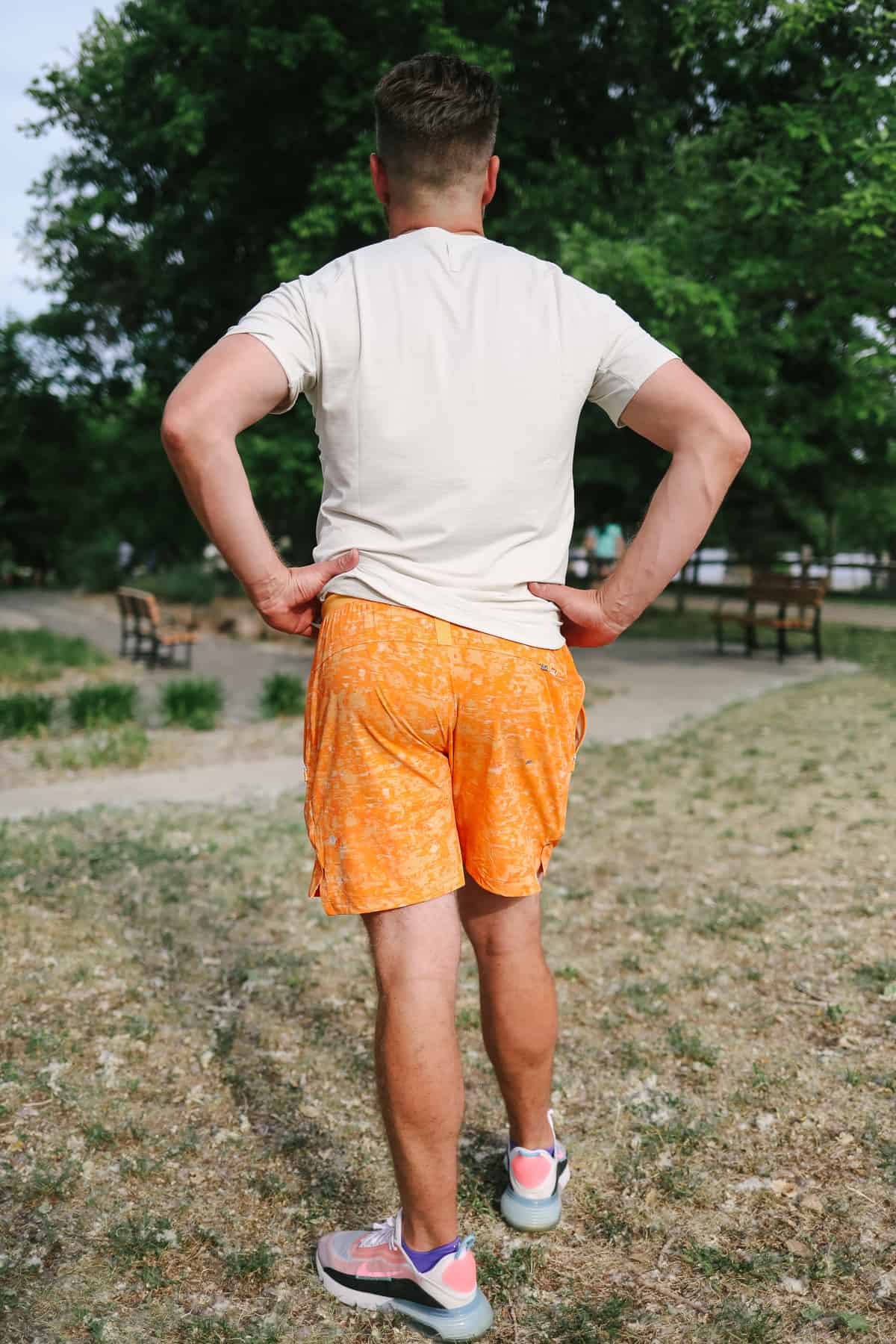 a man standing in a field with his back to the camera.