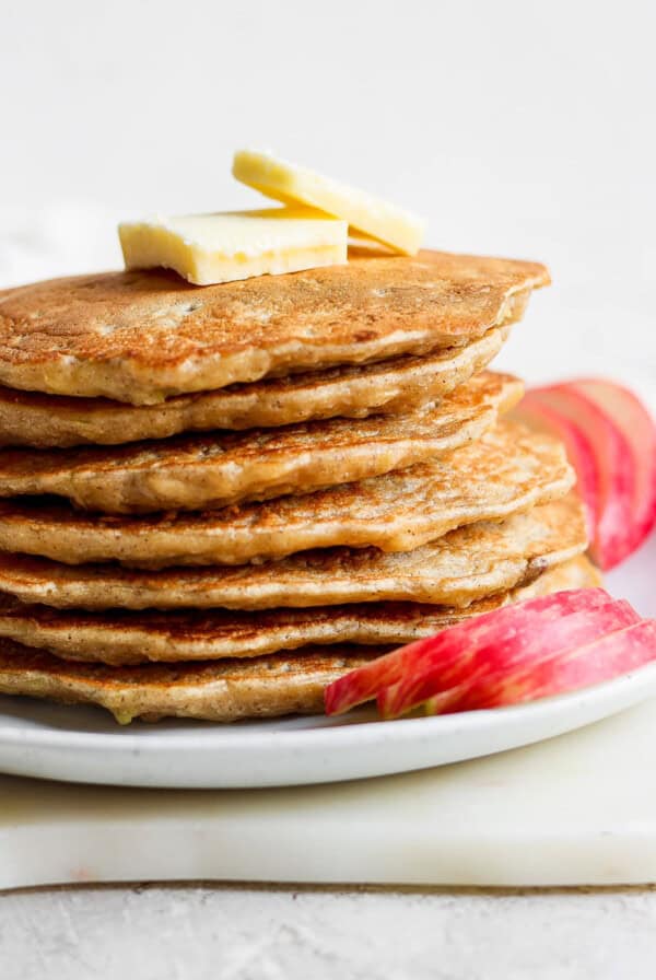 a stack of pancakes with butter on a plate.