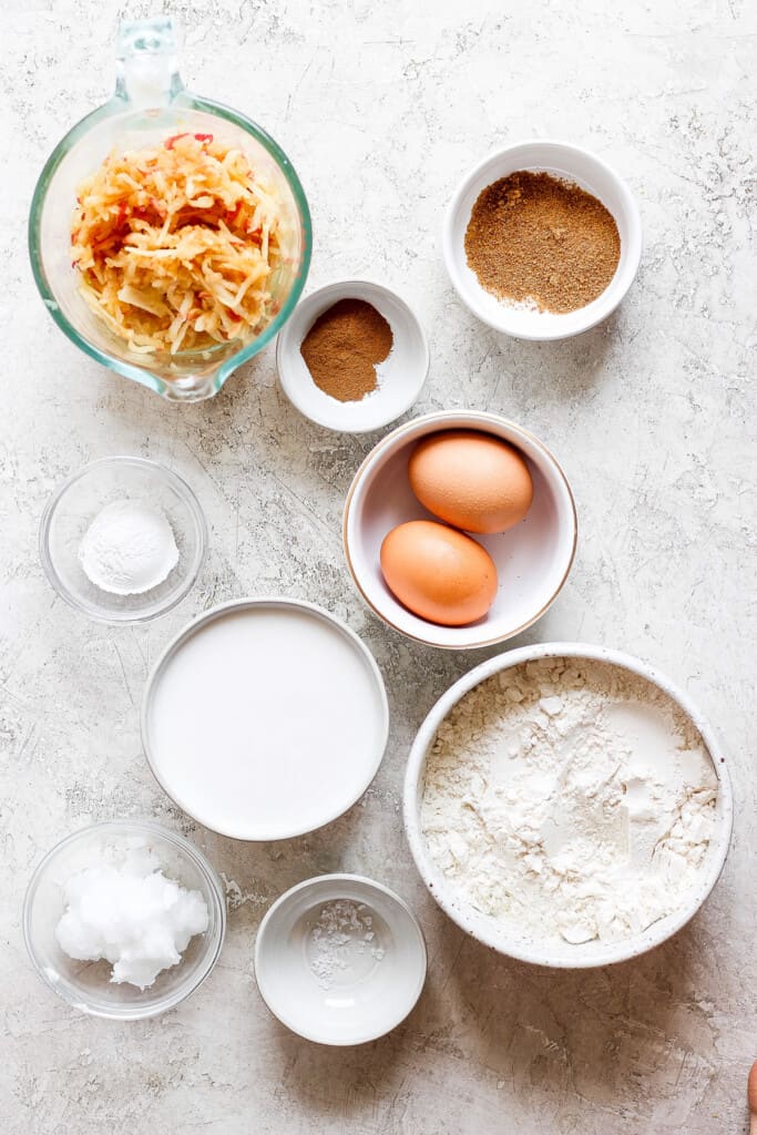 eggs, flour, sugar, and other ingredients are shown on a table.