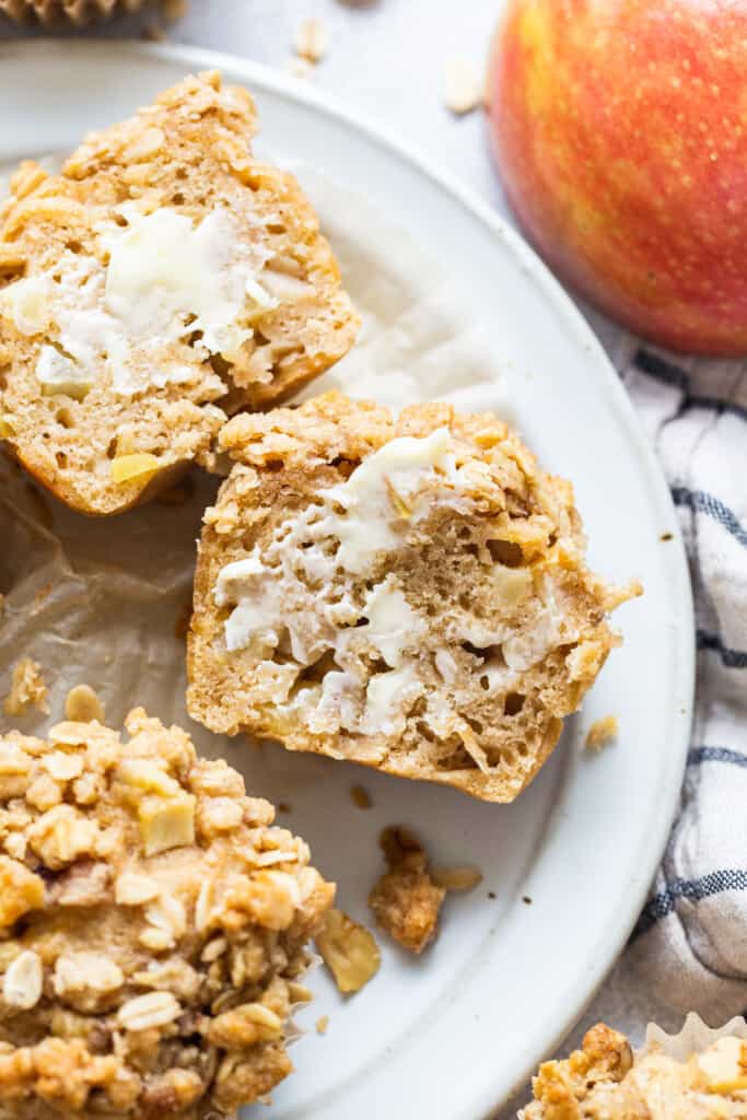 oatmeal apple muffins on a plate with apples.