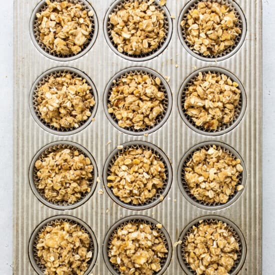 a muffin tin filled with granola muffins.