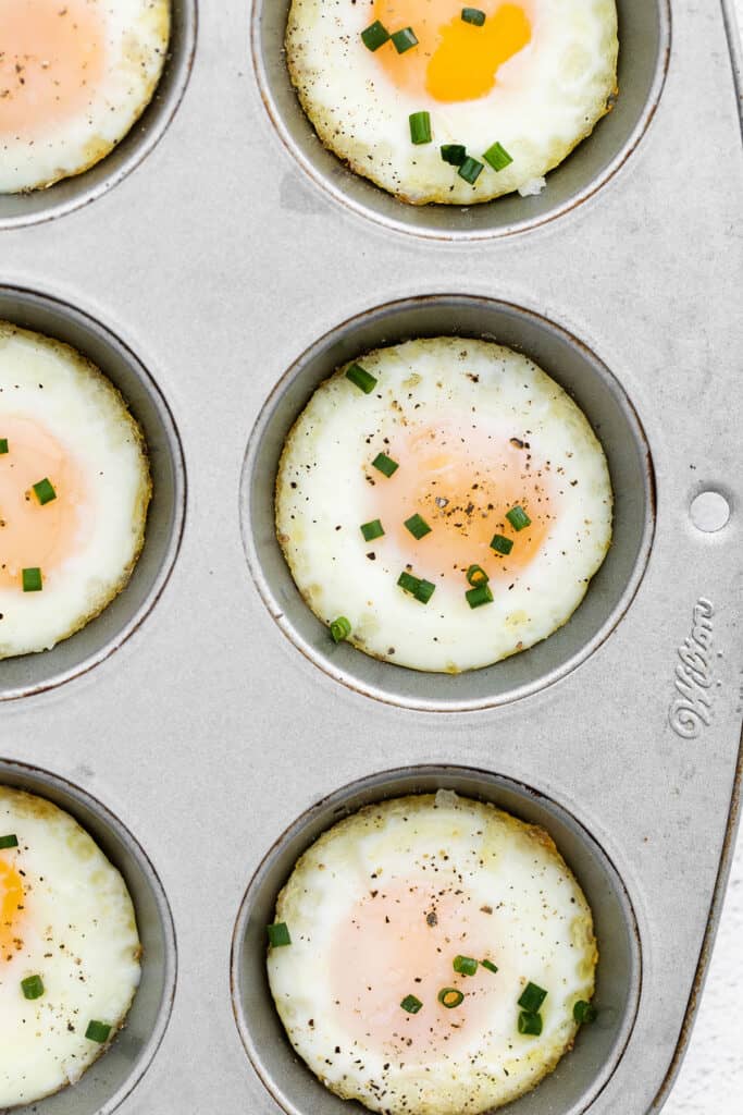 Bake eggs in oven using muffin tin and chives.