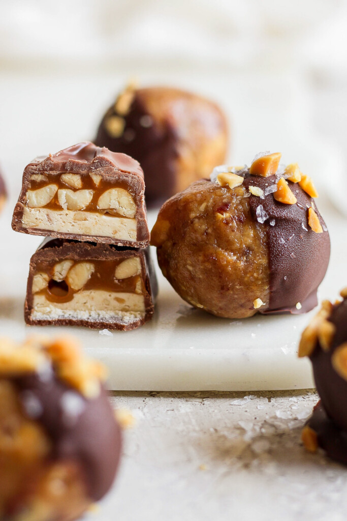 a plate of chocolate covered peanuts on a white plate.