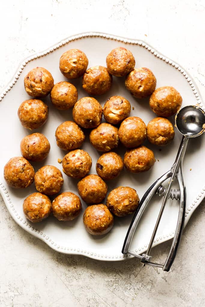 peanut butter balls on a plate with a spatula.