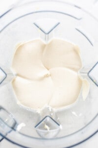 a food processor filled with cream cheese.